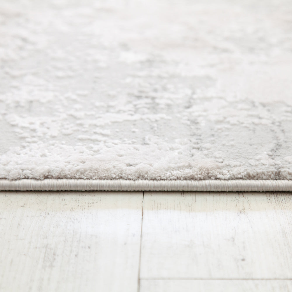 Close up showing edge detail of white/soft grey carpet hall runner. 