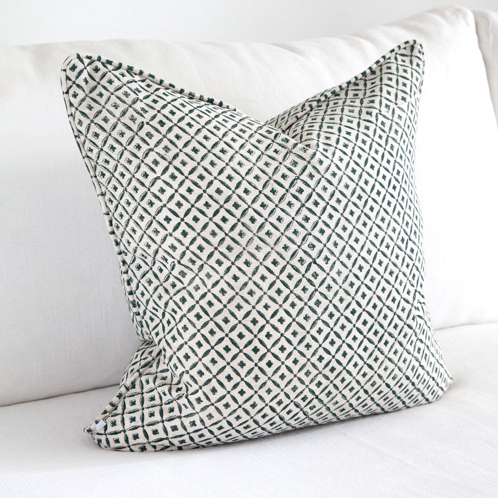 Square linen cushion with clover block printed pattern.