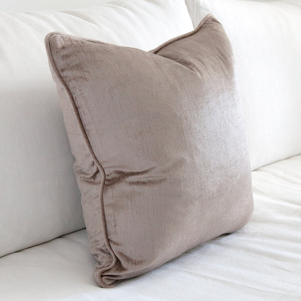 Side view of mauve velvet cushion.