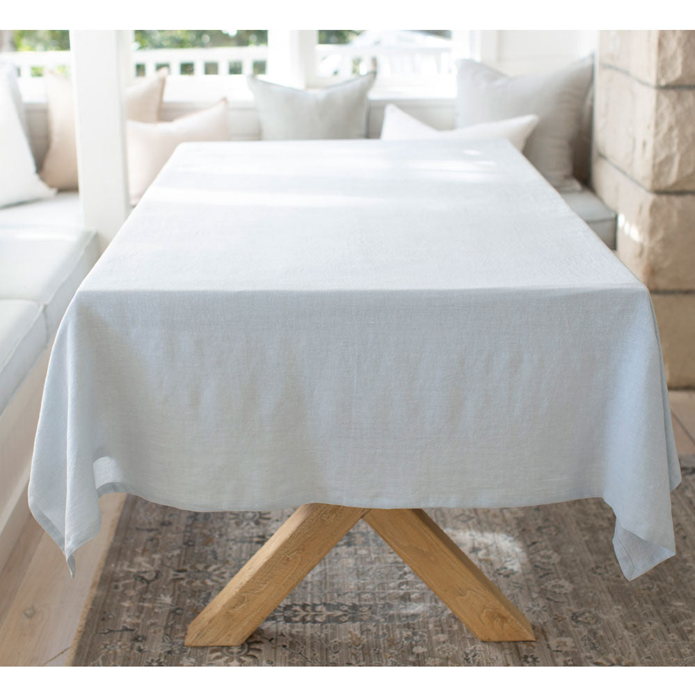 Light blue linen tablecloth on rectangular table.