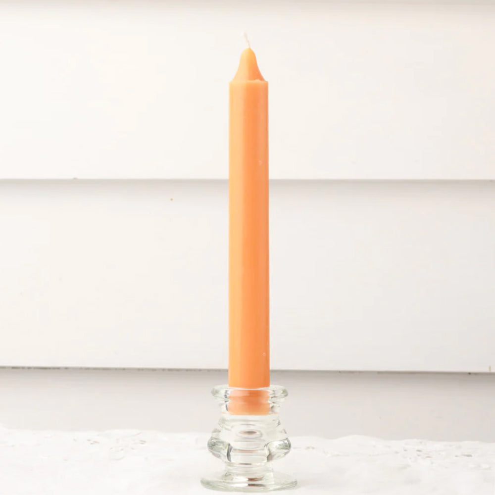 Orange dinner candle in clear glass candle holder