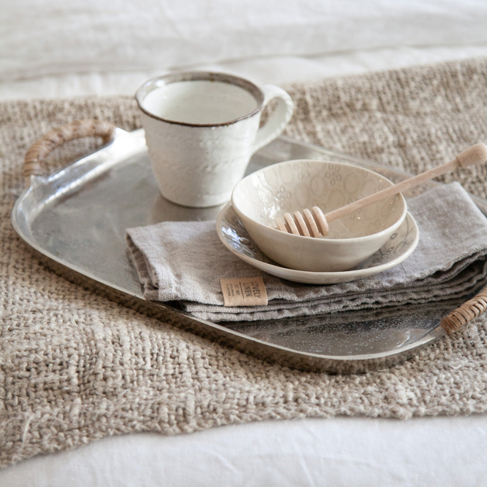 Natural linen napkin on silver breakfast tray.