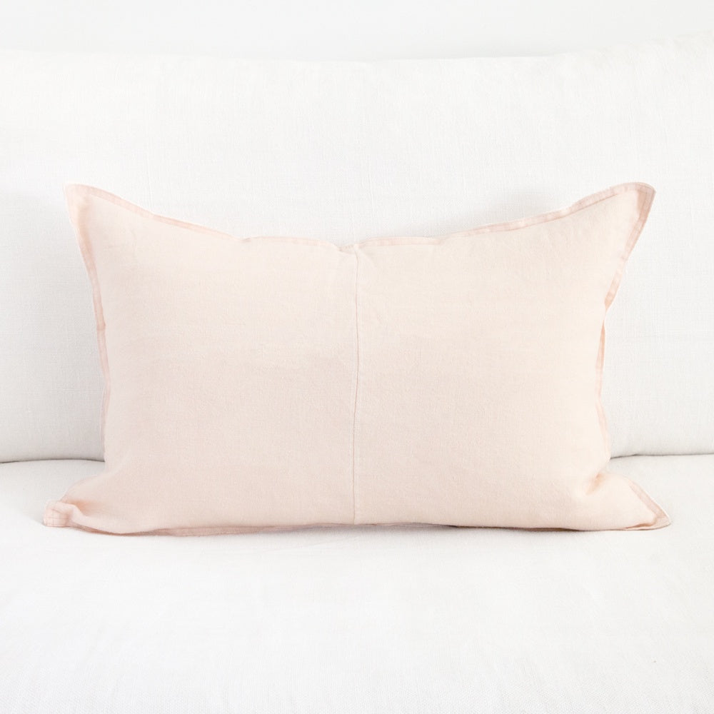 Blush pink rectangular linen cushion.