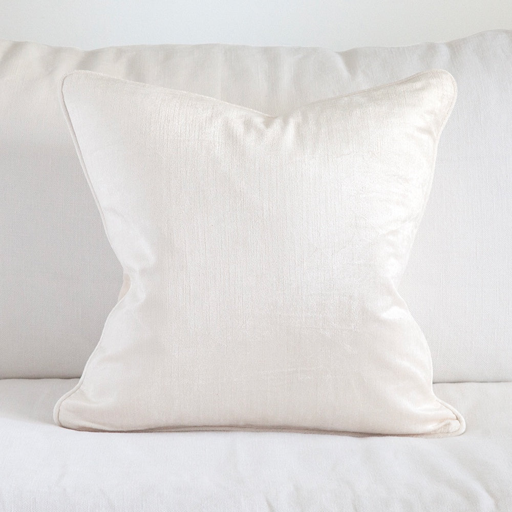 White velvet cushion on white sofa. 