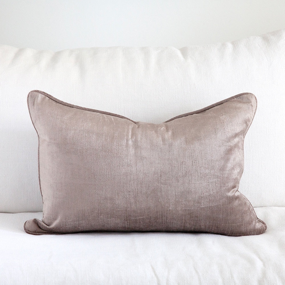 Mauve crushed velvet cushion on white sofa. 