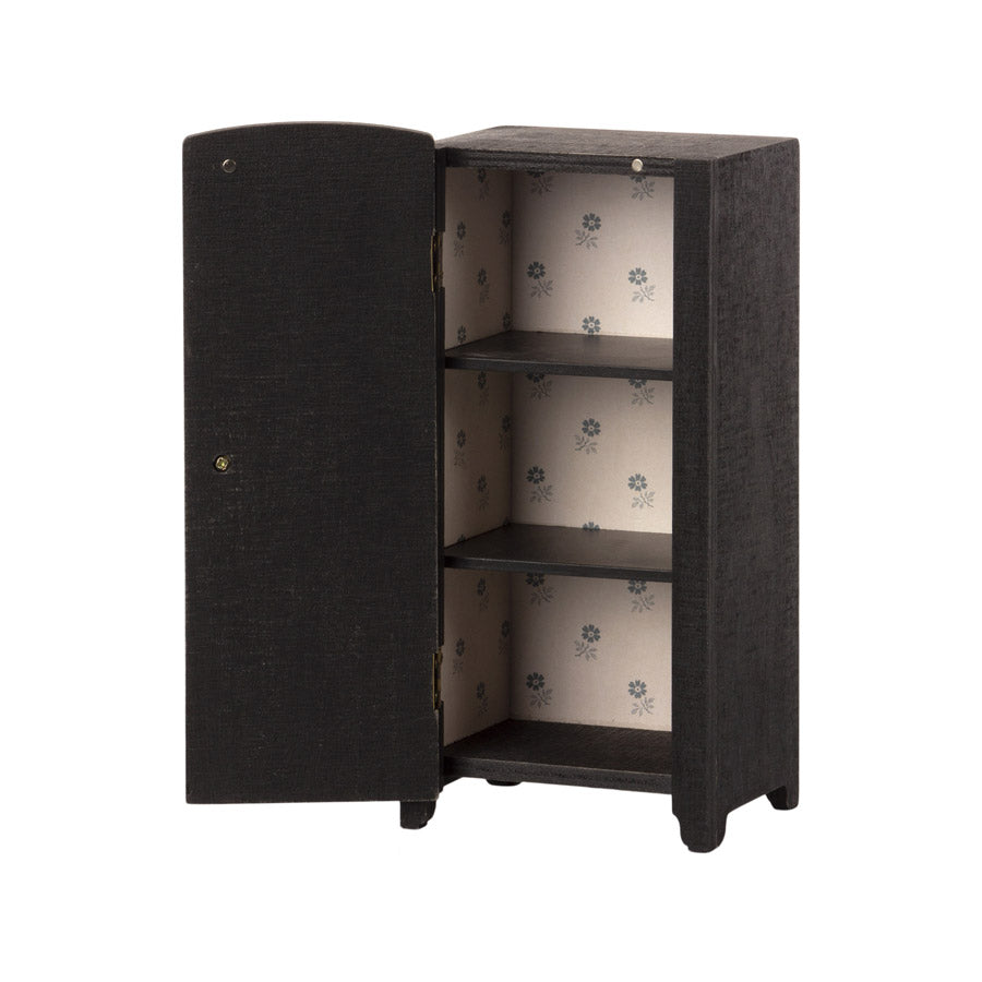 Maileg black cupboard with door open showing floral paper lining. 