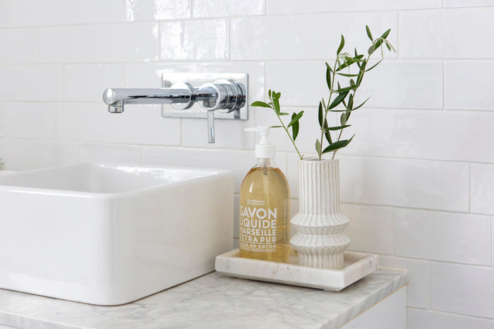 Bathroom accessories styled next to a sink