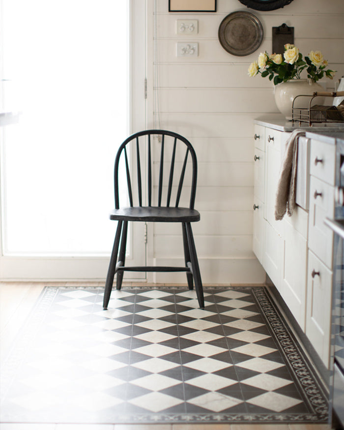 Black & white checker vinyl floor mat styled in a vintage kitchen.