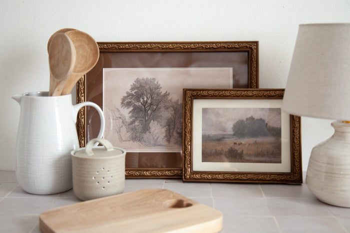 Small artworks styled on a kitchen bench. 