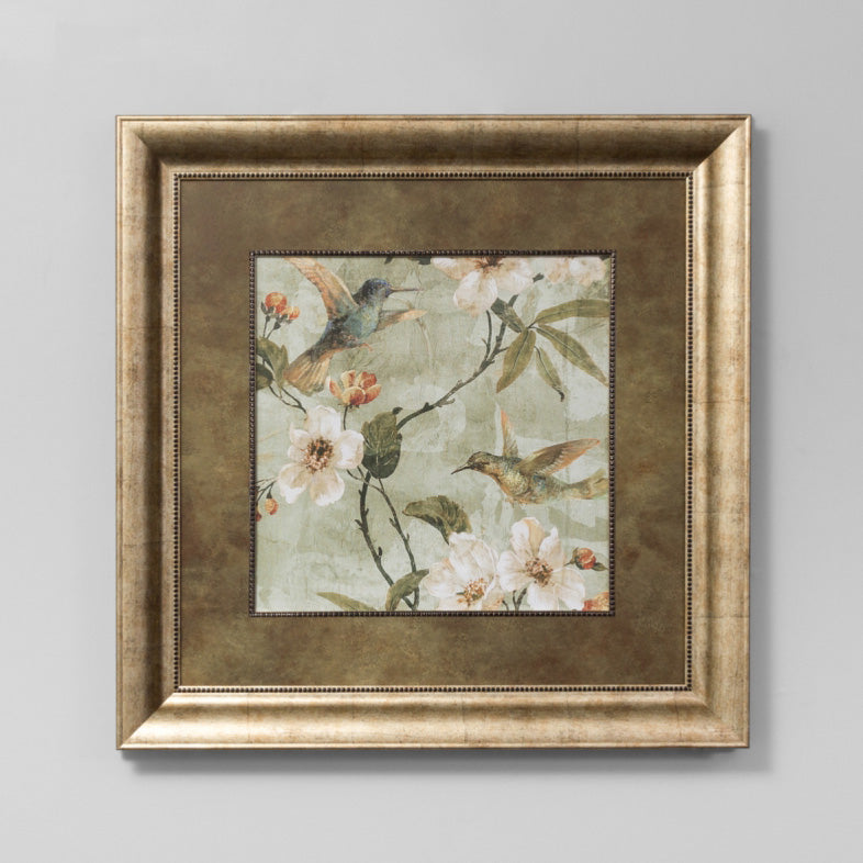 traditional bird and floral framed wall art in a gold frame.