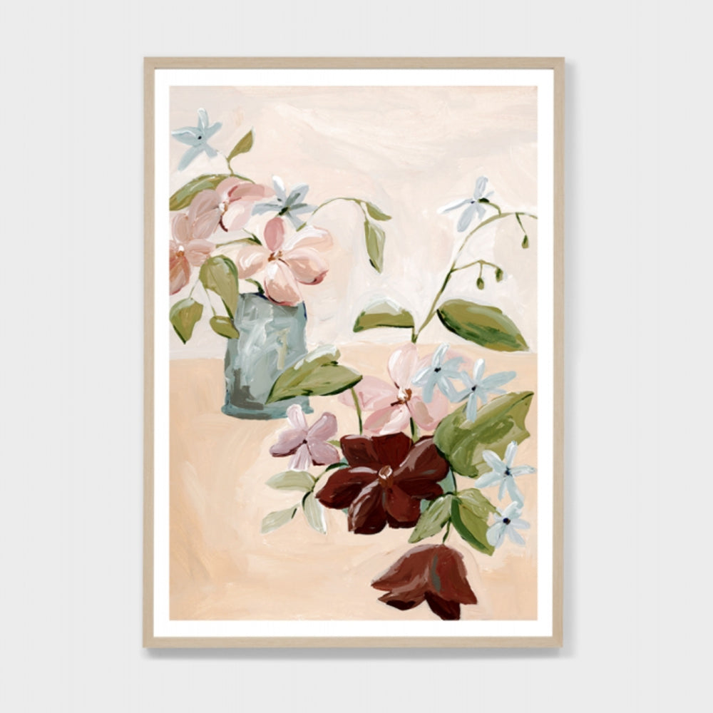 Framed print of a floral painting. The painting features pink, maroon and soft blue flowers with green stems and leaves set against an apricot coloured background.