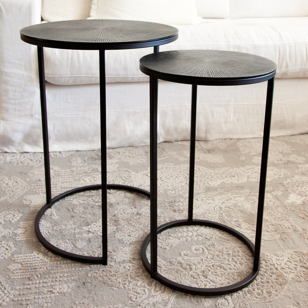 Round nesting side table set with gunmetal coloured tops and black metal legs.