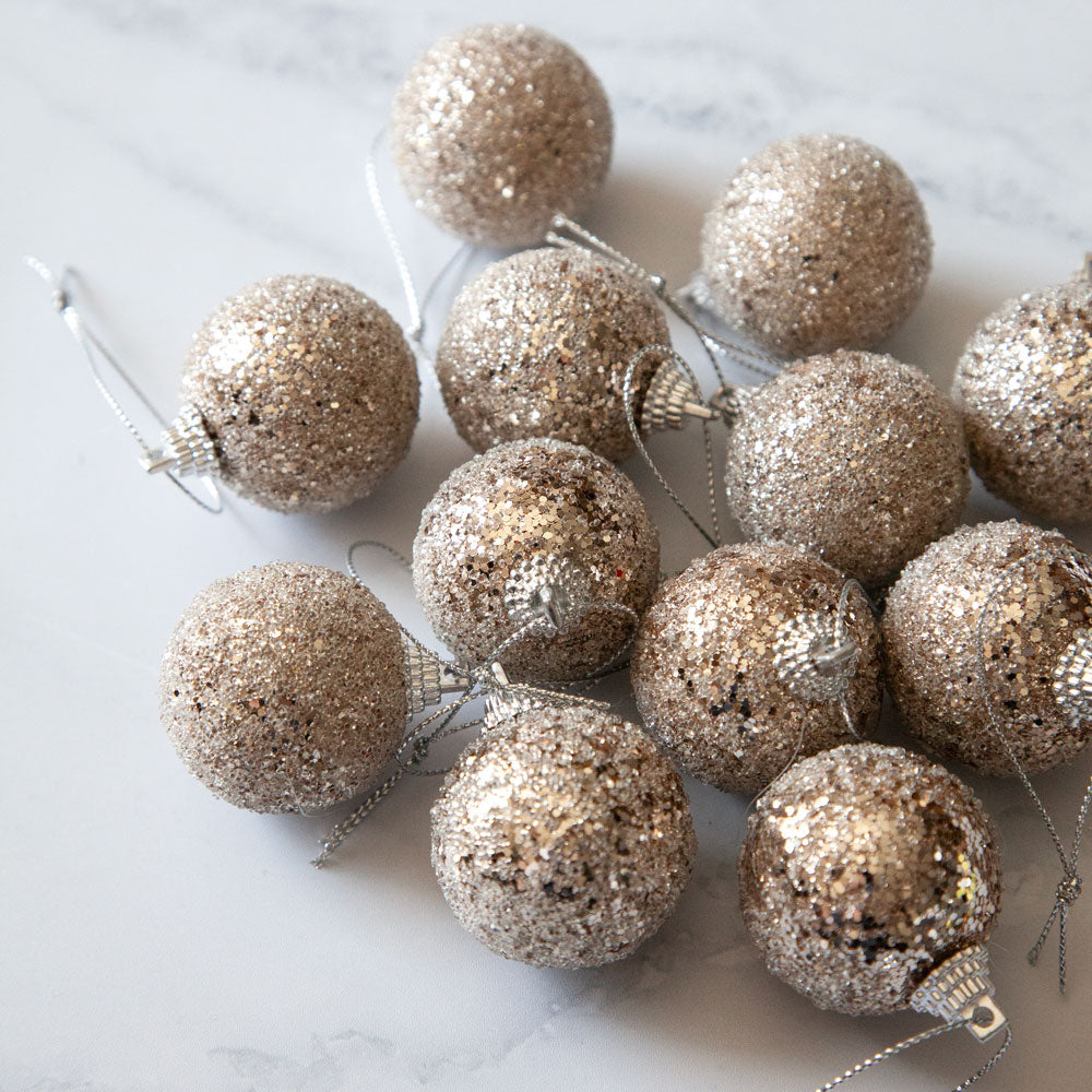 Set of mini bronze champagne coloured glitter baubles.