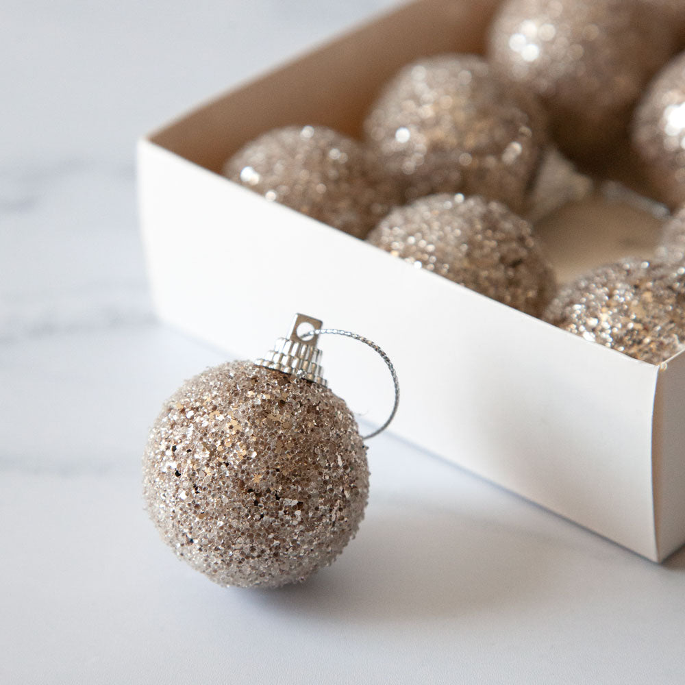 Set of mini bronze champagne coloured glitter baubles.