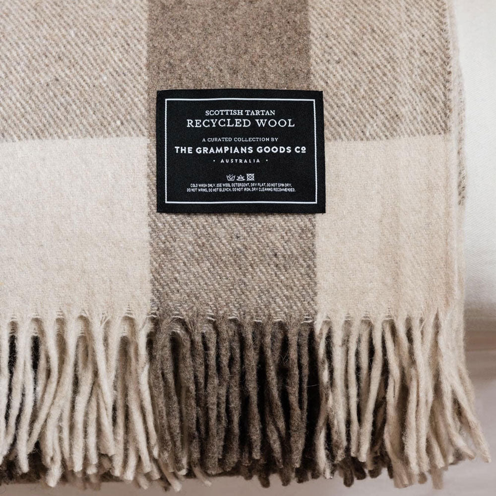 The Grampian Goods Co Brown tartan recycled wool blanket.