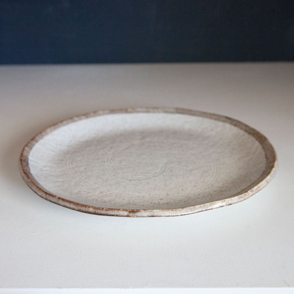 Shirokaratsu ceramic plate with brown rim. 