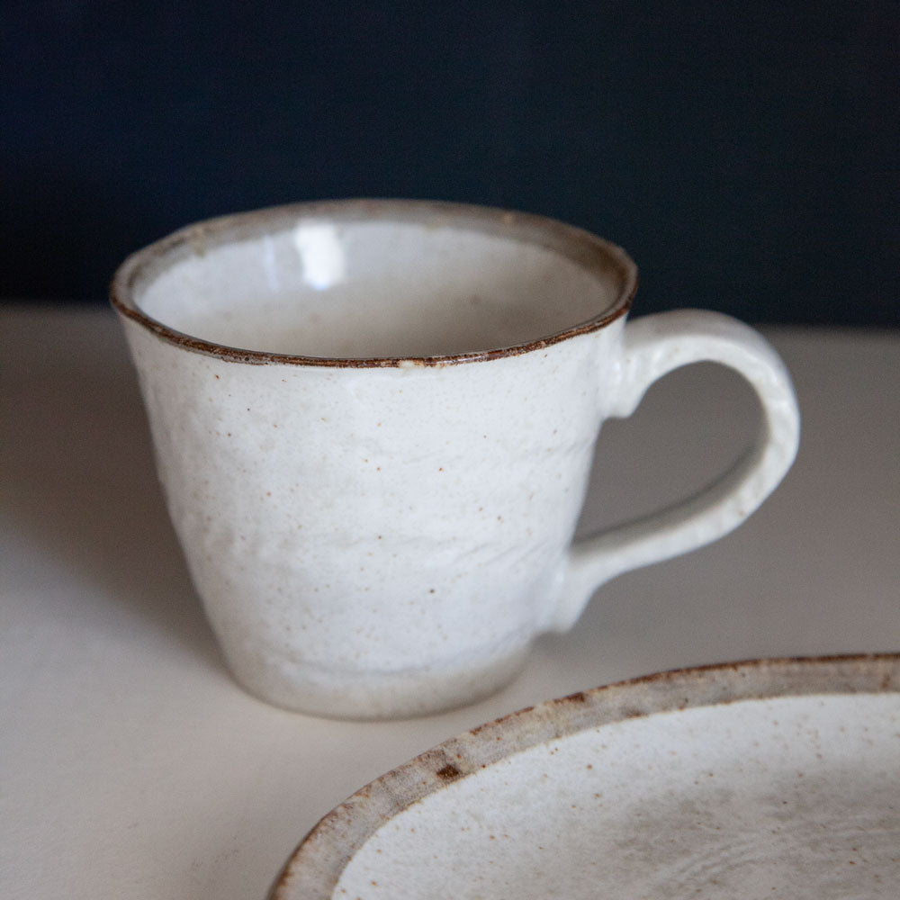 Shirokaratsu ceramic mug with brown rim and matching plate.