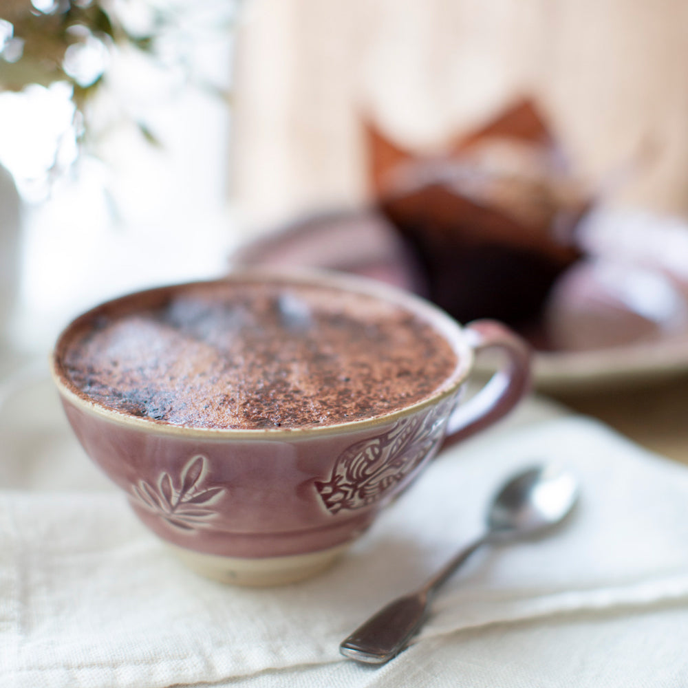 Arabesque Mug in old rose filled with hot chocolate.