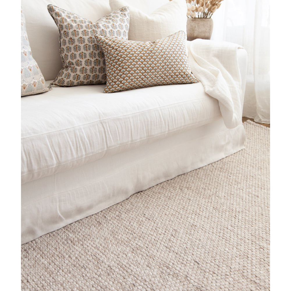 Light coloured indoor outdoor rug with warm tone. 