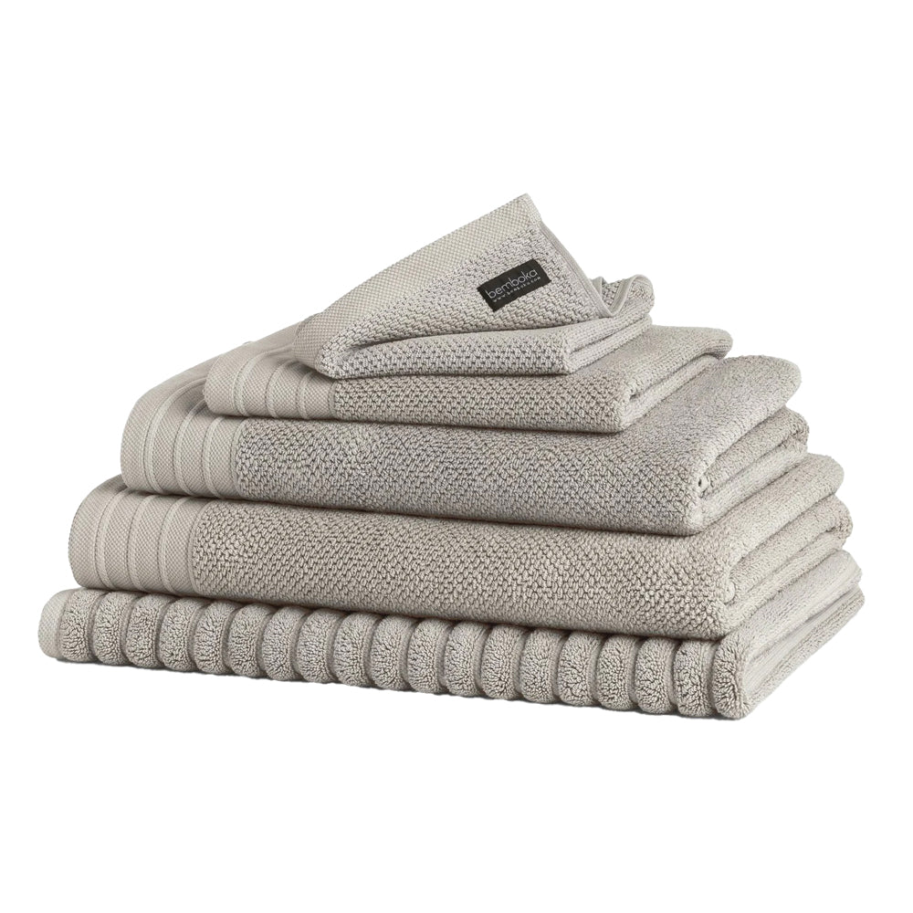 Stack of Bemboka bath towels and bath mat in Linen colour.