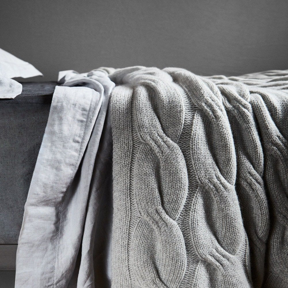 Bemboka Cashmere Chunky Cable Knit Throw on bed.