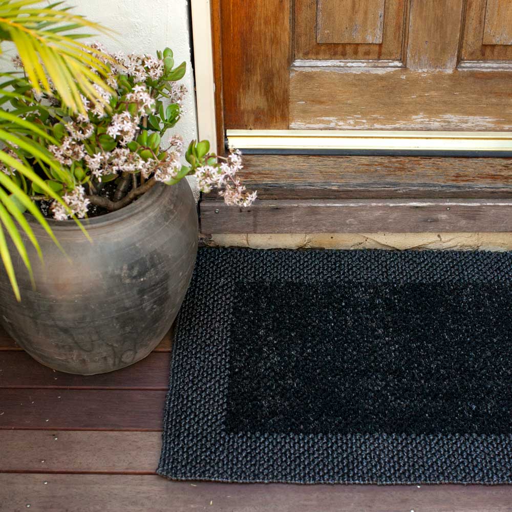 Black waterproof doormat outside front door.