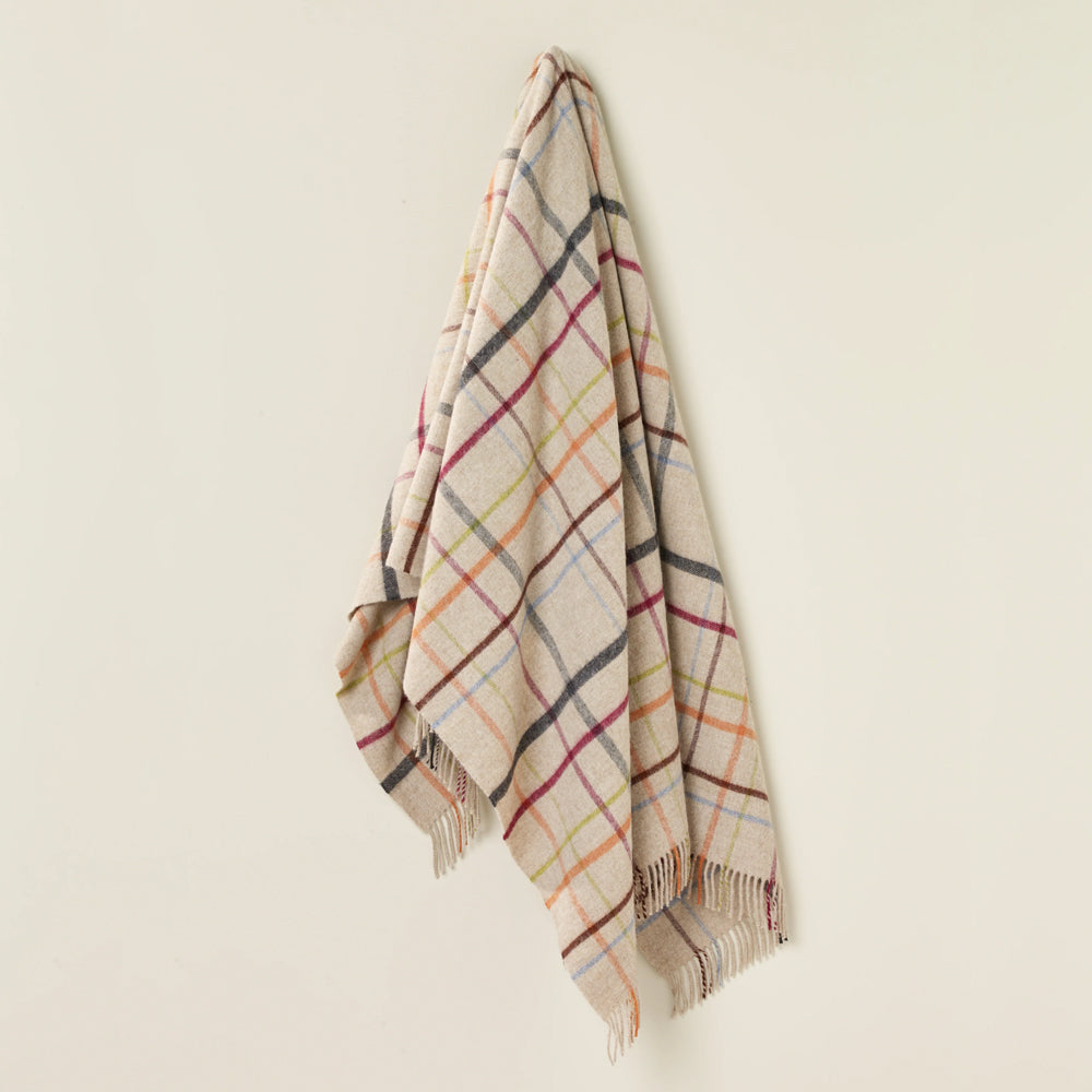 Bronte Beige throw with multicoloured stripes.