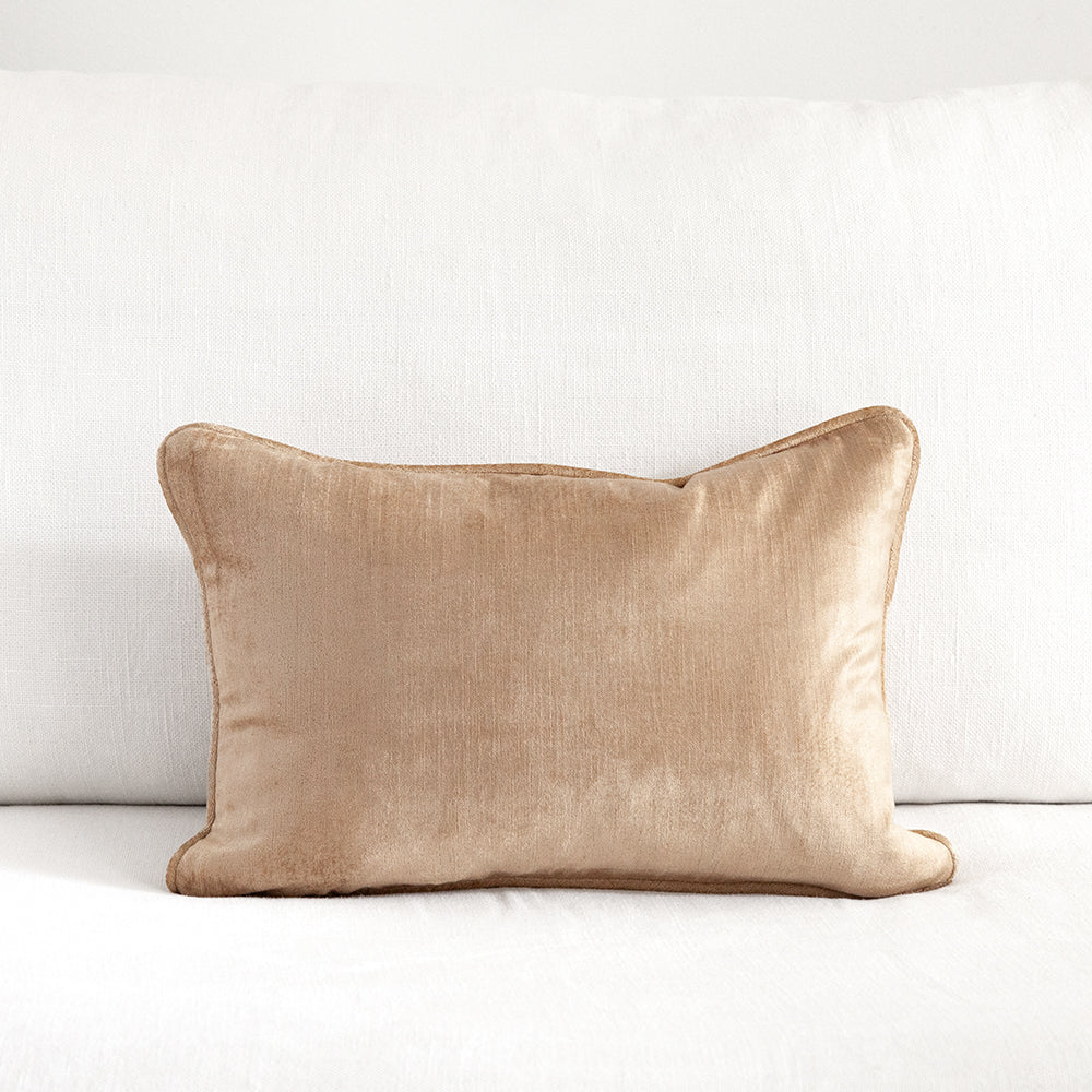 Small beige/gold velvet cushion with piping.