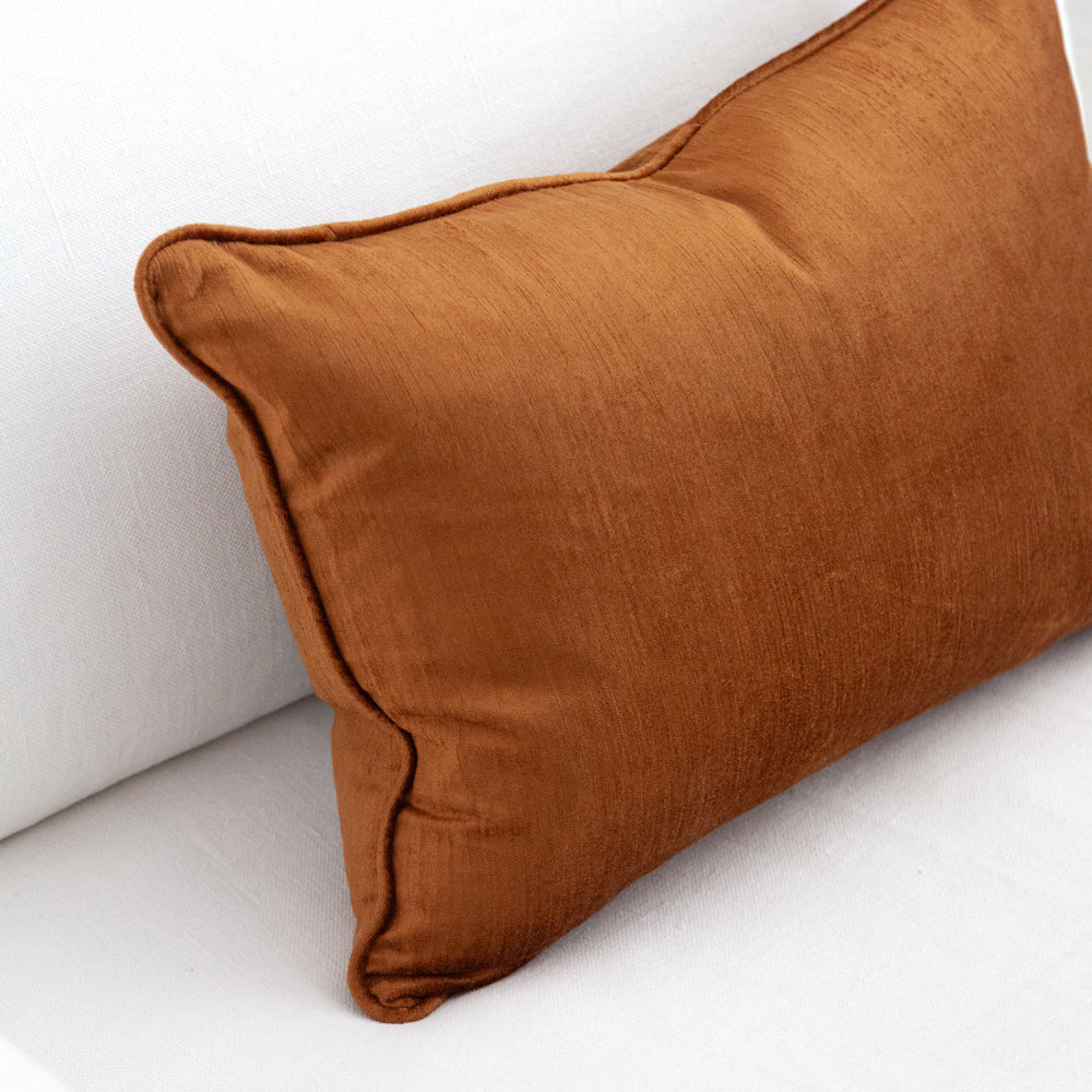 Ochre coloured rectangular velvet cushion.