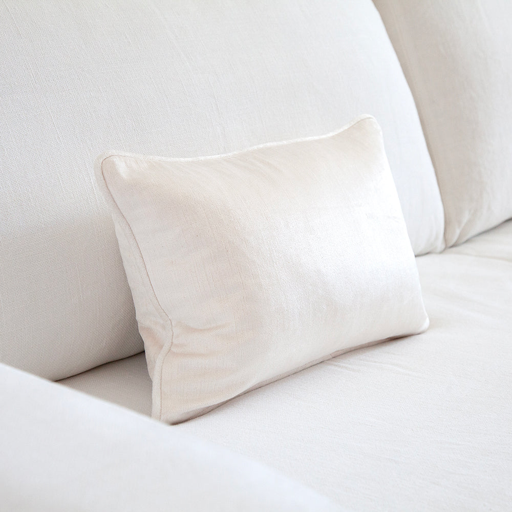 White velvet cushion on white sofa. 