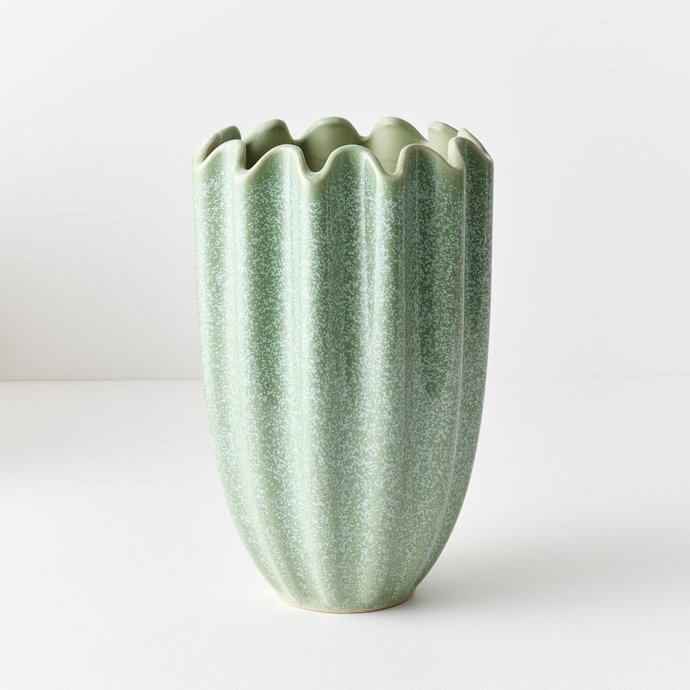 Green textured ceramic vase on a white background