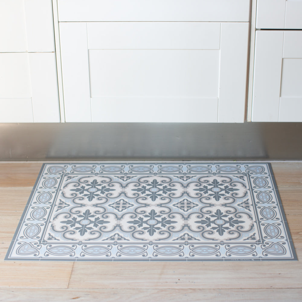 Blue and grey vinyl floor mat in the kitchen. Spanish tile design.