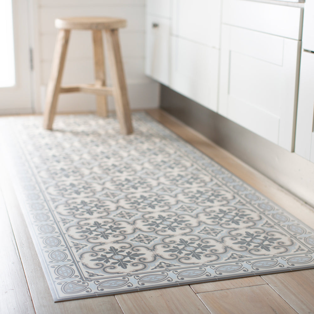 Blue white and grey vinyl floor mat in kitchen. Spanish tile design.