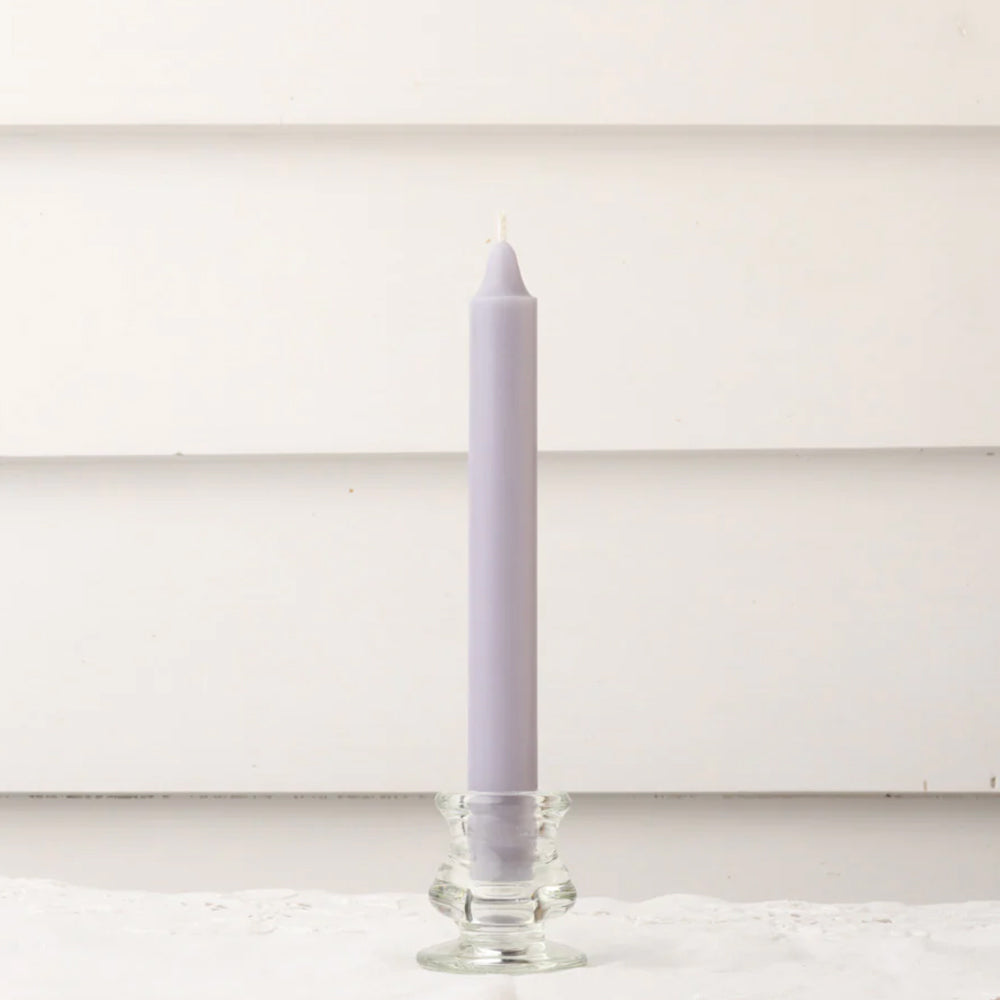 mauve coloured dinner candle with clear glass candlestick.