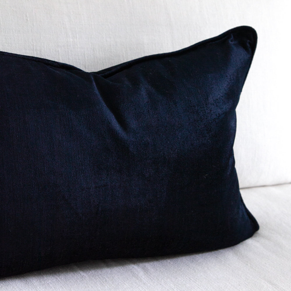 Close up of dark blue velvet cushion.