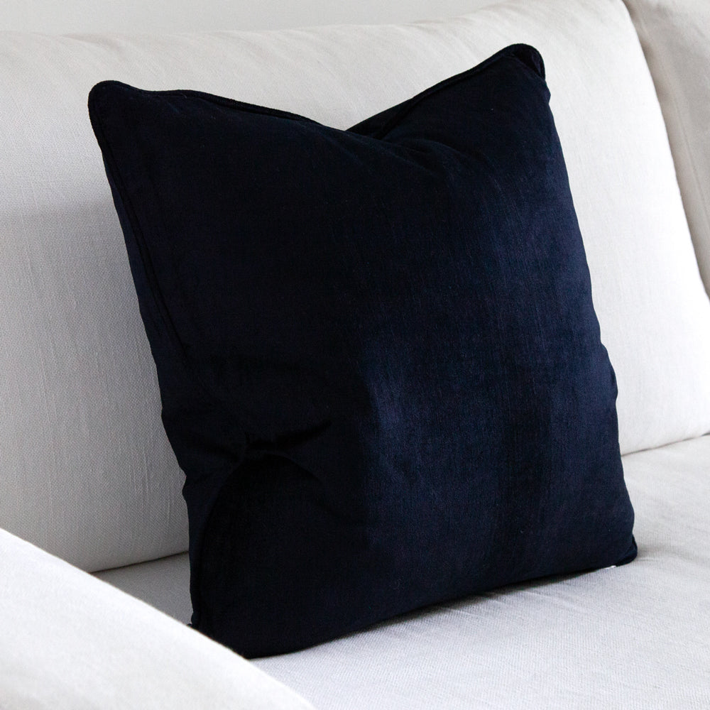 Dark navy blue square velvet cushion.