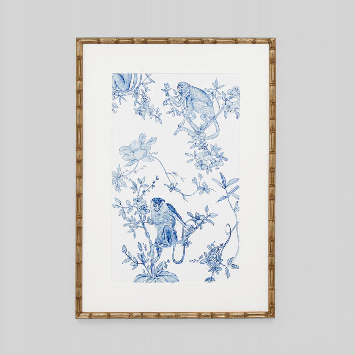 Blue and white floral monkey print in gold bamboo frame.