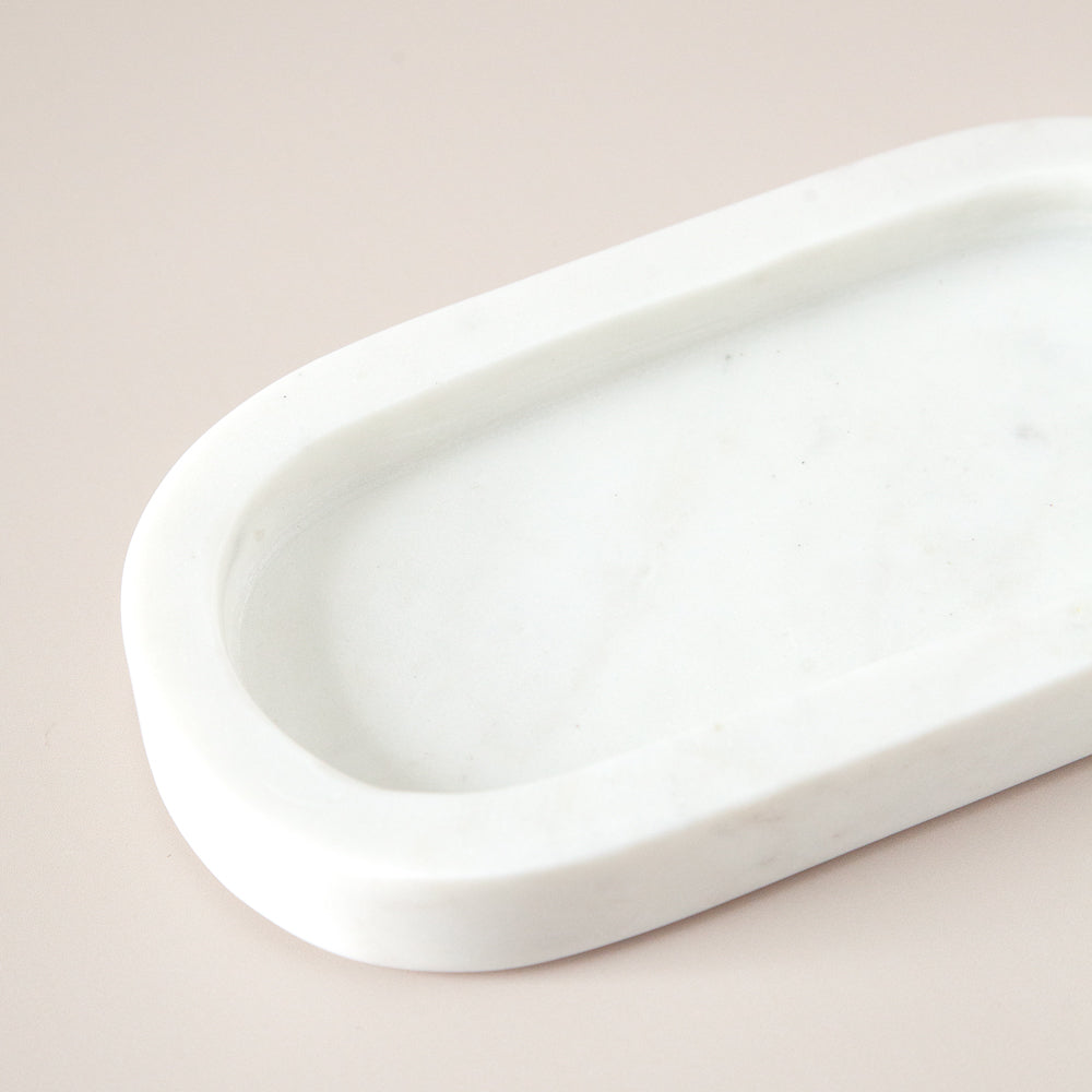 Oval marble dispenser tray for bathroom.