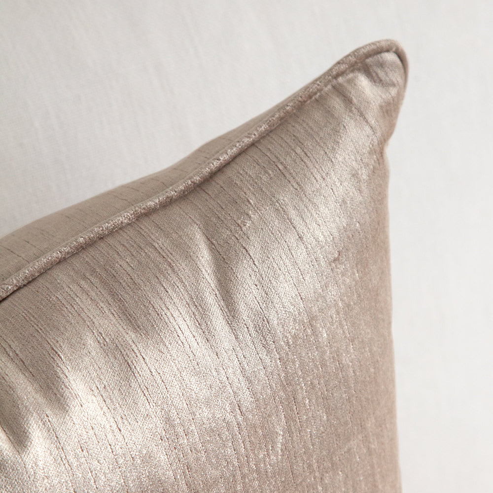 Warm grey square velvet cushion with piped edging.