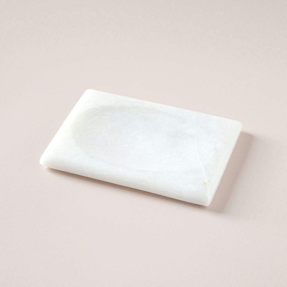 Rectangular marble soap dish with oval soap indent.