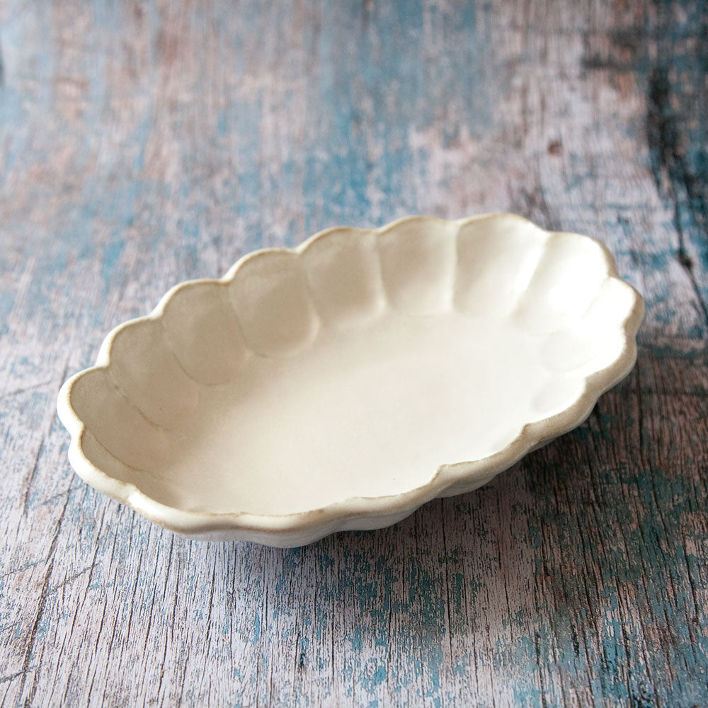 Rinka oval ceramic bowl featuring scalloped edged design resembling a flower.