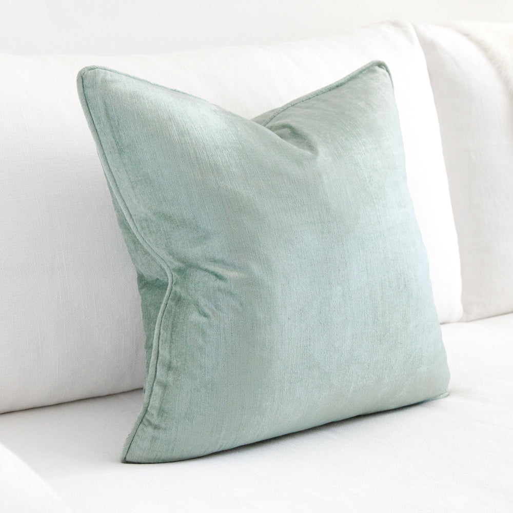 Square velvet cushion in aqua colour. 