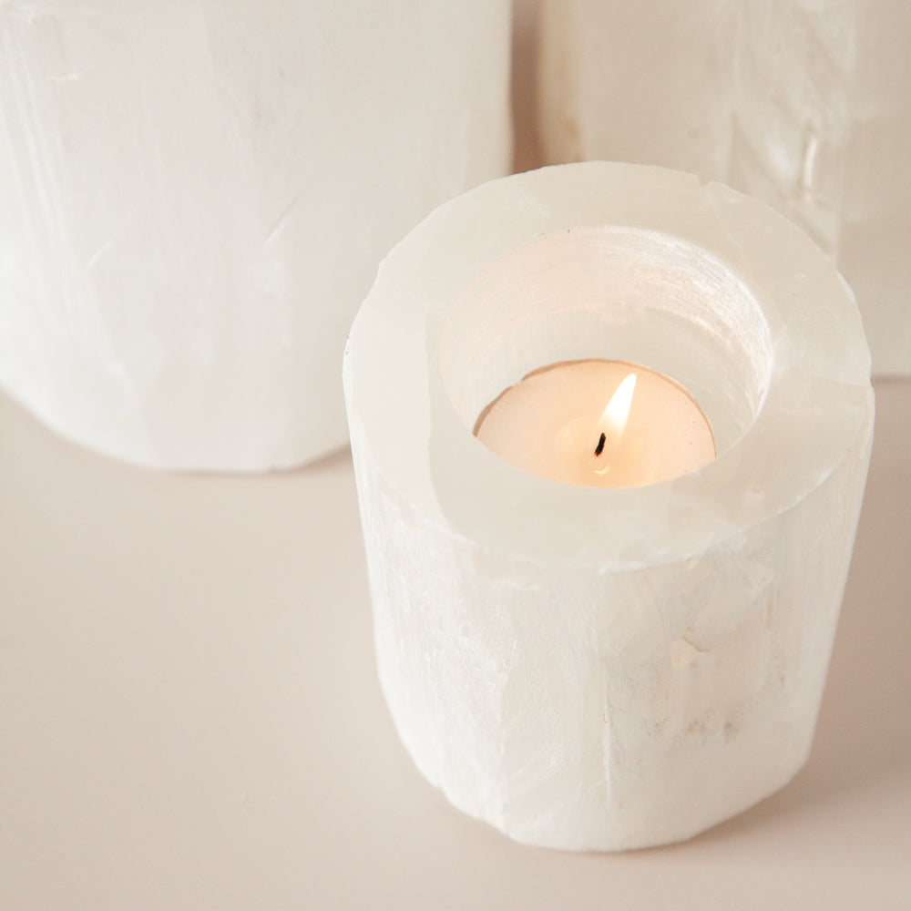 Selenite votive with tealight candle lit.