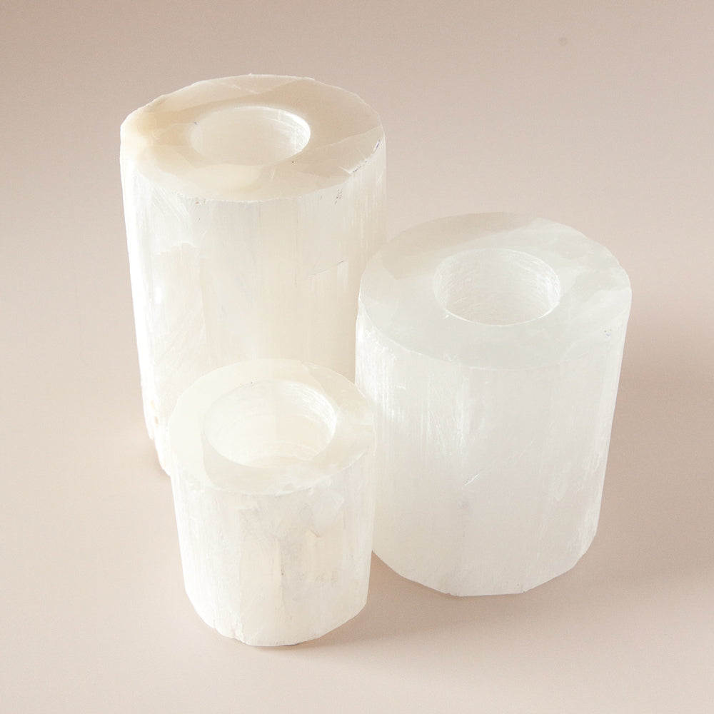 selenite crystal votives in three sizes.