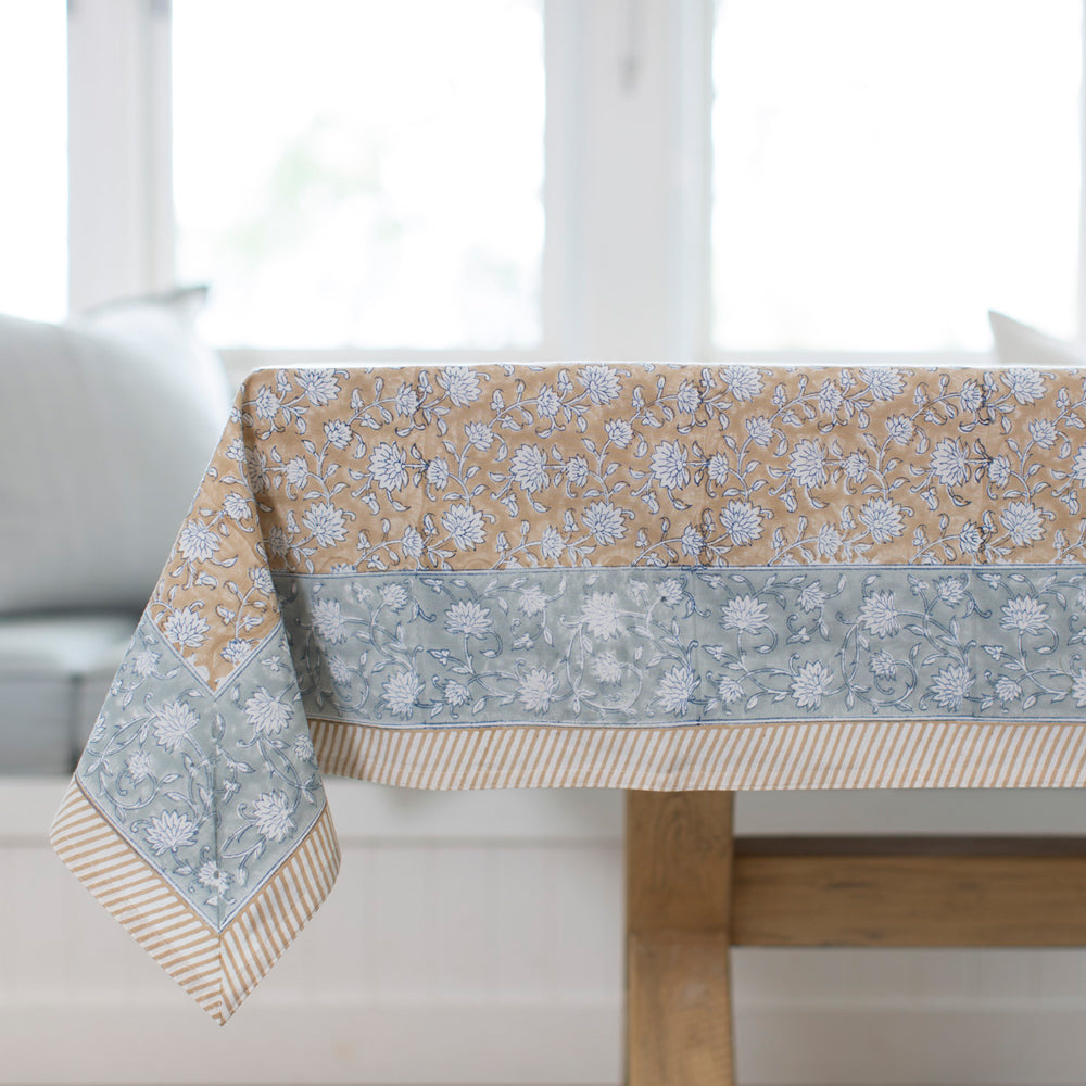 Block printed tablecloth with floral motif and blue border. 