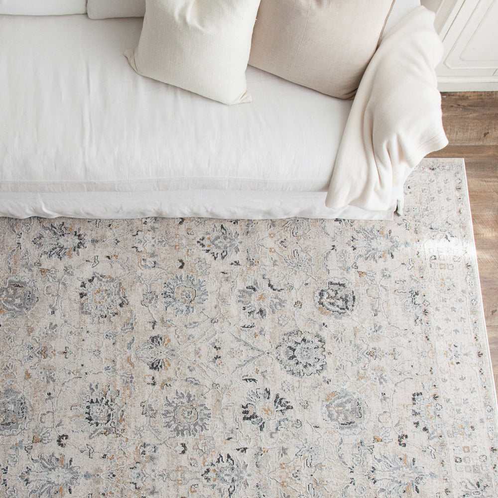 Turkish style rug in off white and blue colours paired with white sofa. 