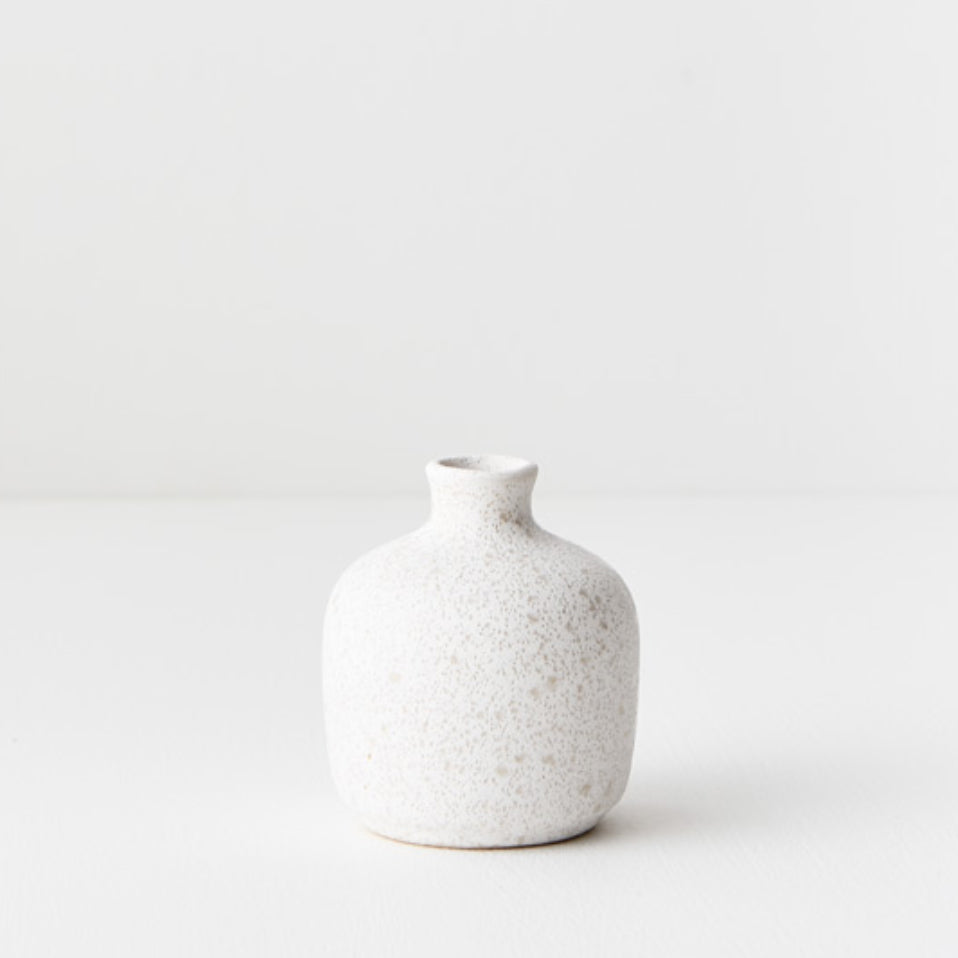 Small white textured ceramic vase.