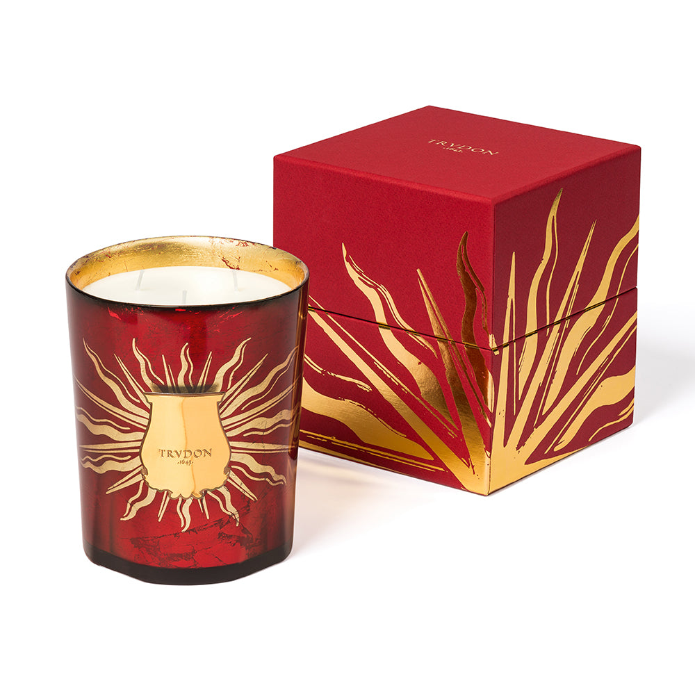 Trudon Christmas 2023 Gloria Candle. Red vessel with gold solar motif.