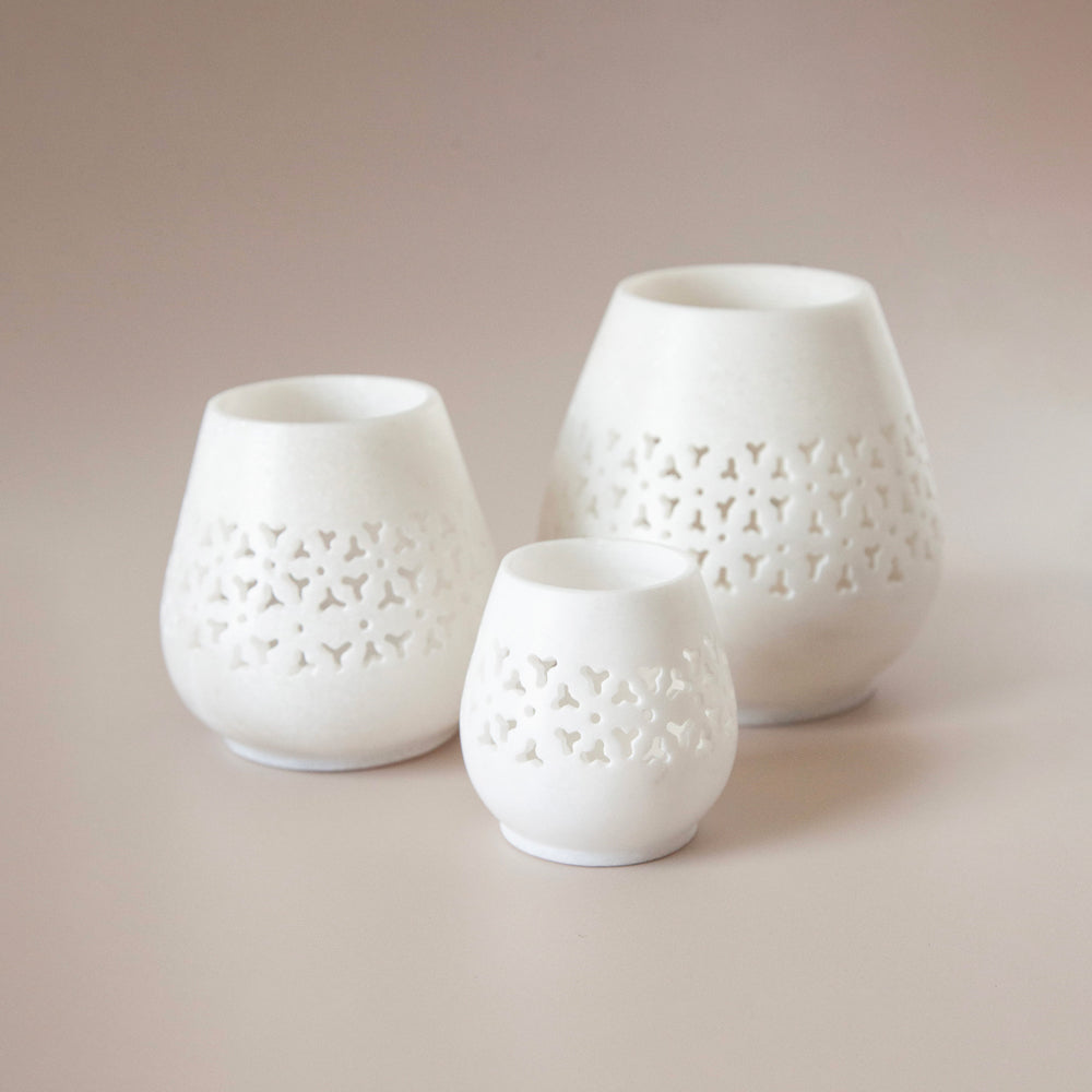 White marble tealight candle holders in three sizes.