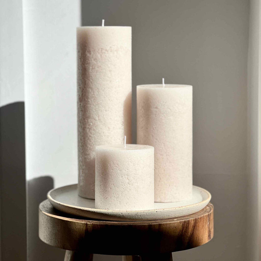 Trio of pillar candles in a soft beige colour.